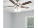 Bedroom featuring a ceiling fan with lights and a view of the adjacent window at 5593 Sw 199Th Ct, Dunnellon, FL 34431