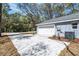 Spacious garage with a concrete driveway and manicured landscaping at 5593 Sw 199Th Ct, Dunnellon, FL 34431