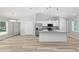 Open concept kitchen and living area featuring a large island, new stainless steel appliances, and white cabinets at 5593 Sw 199Th Ct, Dunnellon, FL 34431