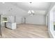 Open floor plan showcasing the kitchen with a central island and stainless steel appliances at 5593 Sw 199Th Ct, Dunnellon, FL 34431