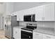 Modern kitchen with stainless steel appliances, granite countertops, and white cabinets at 5593 Sw 199Th Ct, Dunnellon, FL 34431