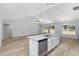 Open concept kitchen features a granite island with a stainless dishwasher and sink at 5593 Sw 199Th Ct, Dunnellon, FL 34431