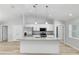 Gourmet kitchen features a large island, stainless appliances, granite countertops, and custom cabinetry at 5593 Sw 199Th Ct, Dunnellon, FL 34431