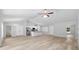 Large living area with an open floor plan to the kitchen, showcasing new floors and neutral paint at 5593 Sw 199Th Ct, Dunnellon, FL 34431