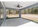 Covered back patio with outdoor ceiling fan, ideal for enjoying the backyard view at 5593 Sw 199Th Ct, Dunnellon, FL 34431