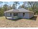 The home features a covered patio and large sliding glass doors that provide easy access to the backyard at 5593 Sw 199Th Ct, Dunnellon, FL 34431
