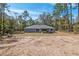 Rear exterior of the home, featuring sliding glass doors and a spacious backyard at 5593 Sw 199Th Ct, Dunnellon, FL 34431