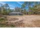Rear exterior of the home, with view of a spacious, partially wooded backyard at 5593 Sw 199Th Ct, Dunnellon, FL 34431