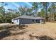 Exterior view of the home and yard with an air conditioning unit visible at 5593 Sw 199Th Ct, Dunnellon, FL 34431