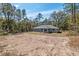 Aerial shot of the back of the home in a wooded lot, featuring a patio at 5593 Sw 199Th Ct, Dunnellon, FL 34431
