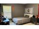A bedroom with a single bed and decorative sports flags on the wall at 1991 Sanderlin Point Loop, Apopka, FL 32703