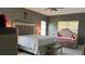 This bedroom has a decorative cross on the wall, a bed, and a couch at 1991 Sanderlin Point Loop, Apopka, FL 32703