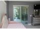 Bedroom featuring a pink daybed, sliding glass doors leading to outdoor space, and stylish gray walls at 1991 Sanderlin Point Loop, Apopka, FL 32703
