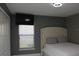 Neutral bedroom features soft headboard and window-mounted TV, creating a relaxing and modern space at 1991 Sanderlin Point Loop, Apopka, FL 32703