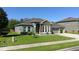 Charming single-Gathering home with stone accents, lush lawn, and manicured landscaping, full of curb appeal at 1991 Sanderlin Point Loop, Apopka, FL 32703