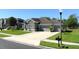 A beautiful home featuring a three-car garage and a well-manicured lawn at 1991 Sanderlin Point Loop, Apopka, FL 32703