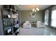 A bright living room with two white chairs and a modern lighting fixture at 1991 Sanderlin Point Loop, Apopka, FL 32703