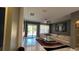Bright living room with sliding glass doors and a modern sectional sofa at 1991 Sanderlin Point Loop, Apopka, FL 32703
