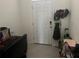 A tidy entryway features a white door, tile floors, and wall-mounted hooks, maximizing space at 1026 Lido Dr, Howey In The Hills, FL 34737