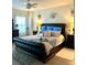 Comfortable primary bedroom features a leather-trimmed bed, a ceiling fan, and ample natural light at 424 Luna Bella Ln # 330, New Smyrna Beach, FL 32168