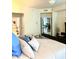 Comfortable primary bedroom featuring a leather-trimmed bed, and ample natural light at 424 Luna Bella Ln # 330, New Smyrna Beach, FL 32168