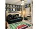 Den with plush leather seating and sports themed decor at 424 Luna Bella Ln # 330, New Smyrna Beach, FL 32168