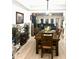 Open-concept dining area with wood table, wine storage, and ample natural light at 424 Luna Bella Ln # 330, New Smyrna Beach, FL 32168