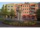 Beautiful condo building featuring a central fountain, lush landscaping, and vibrant colors at 424 Luna Bella Ln # 330, New Smyrna Beach, FL 32168