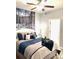 Serene bedroom featuring a ceiling fan, scenic wall art, and a beautifully coordinated bed at 424 Luna Bella Ln # 330, New Smyrna Beach, FL 32168