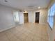 Spacious bedroom with neutral tile floors, a ceiling fan, and multiple windows at 7990 Midway Drive Ter # M103, Ocala, FL 34472