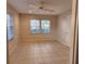 Bright bedroom features two windows and a ceiling fan for a fresh and inviting space at 7990 Midway Drive Ter # M103, Ocala, FL 34472