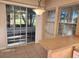 A brightly lit dining area with tiled floor, a sliding glass door to the patio, and a breakfast bar at 7990 Midway Drive Ter # M103, Ocala, FL 34472