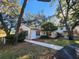 Quaint two-story house surrounded by mature trees, with a charming, freshly painted exterior and well-manicured lawn at 7990 Midway Drive Ter # M103, Ocala, FL 34472