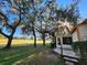 Charming home featuring a screened-in patio, set amidst lush greenery with mature trees, and a well-manicured lawn at 7990 Midway Drive Ter # M103, Ocala, FL 34472