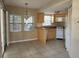 Bright kitchen with tile flooring, white appliances, and adjacent dining area at 7990 Midway Drive Ter # M103, Ocala, FL 34472