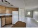 Open kitchen and living area with tile floors and white appliances at 7990 Midway Drive Ter # M103, Ocala, FL 34472