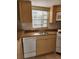 Functional kitchen featuring white appliances, a stainless sink, and ample counter space at 7990 Midway Drive Ter # M103, Ocala, FL 34472