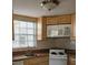 Well-lit kitchen featuring a stainless steel sink, white microwave, and neutral-toned cabinetry at 7990 Midway Drive Ter # M103, Ocala, FL 34472