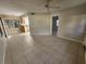 Open-concept living room featuring tile flooring, ceiling fan, and adjacent kitchen at 7990 Midway Drive Ter # M103, Ocala, FL 34472