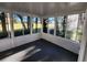 Bright sunroom featuring panoramic views of the outdoors through large windows, and a sleek gray floor at 7990 Midway Drive Ter # M103, Ocala, FL 34472
