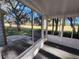 Enclosed sunroom showcasing expansive windows with scenic outdoor views, complemented by neutral flooring and bright interior at 7990 Midway Drive Ter # M103, Ocala, FL 34472