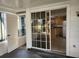 Enclosed porch with sliding glass doors that lead to the kitchen featuring stainless appliances at 7990 Midway Drive Ter # M103, Ocala, FL 34472