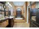 Luxurious bathroom with a soaking tub, chandelier, and elegant vanity, offering a spa-like experience at 4435 Fairway Oaks Dr, Mulberry, FL 33860