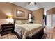 Cozy bedroom with a wicker bed frame, warm lighting, and a decorative painting on the wall at 4435 Fairway Oaks Dr, Mulberry, FL 33860