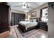 Comfortable bedroom with a woven bed frame, warm lighting, and a hardwood floor, creating a cozy retreat at 4435 Fairway Oaks Dr, Mulberry, FL 33860