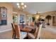 Elegant dining room with a wooden table, wicker chairs, and a view of the open-concept living area at 4435 Fairway Oaks Dr, Mulberry, FL 33860