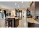 Open kitchen featuring a center island with breakfast bar, stainless steel appliances, and ample counter space at 4435 Fairway Oaks Dr, Mulberry, FL 33860