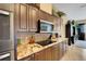 Close-up view of gourmet kitchen with granite countertops, stainless steel appliances, and a stylish backsplash at 4435 Fairway Oaks Dr, Mulberry, FL 33860
