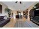 Spacious living room with tile flooring, a ceiling fan, and an open floor plan leading to the kitchen at 4435 Fairway Oaks Dr, Mulberry, FL 33860