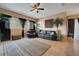 Inviting living room with a leather sofa set, large windows, and indoor plants for a relaxing ambiance at 4435 Fairway Oaks Dr, Mulberry, FL 33860